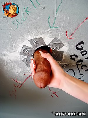 Shy-looking blonde with blue eyes sucking cocks via a glory hole